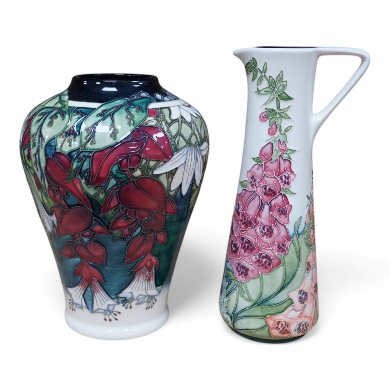 A Moorcroft ‘Nostalgia’ pattern vase together with a similar ‘Foxglove’ pattern ewer, 24.5cm. Condition - good, some crazing